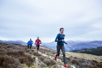 Friends jogging in mountains — Stock Photo
