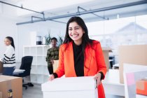 Portrait confident businesswoman moving into new office — Stock Photo