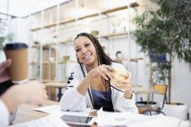 Businesswoman drinking coffee in meeting — Stock Photo