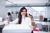 Portrait confident businesswoman moving into new office — Stock Photo