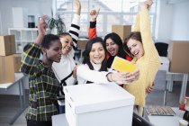 Happy businesswomen moving into new office, taking selfie — Stock Photo