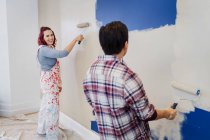 Happy couple painting wall — Stock Photo