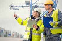 Dock worker and manager talking at shipyard — Stock Photo