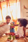 Father and daughter playing with wood blocks — Stock Photo