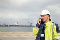 Dock manager with walkie-talkie at shipyard — Stock Photo