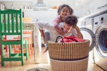 Playful father and daughter doing laundry — Stock Photo