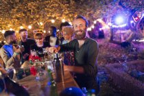Portrait happy man bartending for friends at garden party — Stock Photo