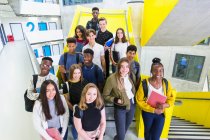Portrait confident junior high students on stairs — Stock Photo