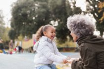 Grandmother and granddaughter playing at playground — Stock Photo