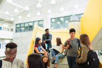 Junior high students talking at stairs — Stock Photo