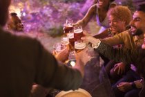 Freunde stoßen bei Gartenparty auf Biergläser an — Stockfoto
