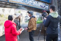 Young adults vlogging under urban bridge — Stock Photo