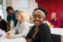 Portrait confident young female community college student in classroom — Stock Photo