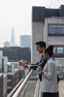 Les gens d'affaires parlent sur un balcon ensoleillé et urbain — Photo de stock
