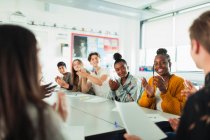 Happy high school students clapping in debate class — Stock Photo