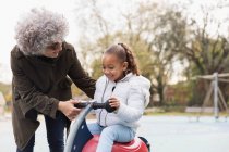 Grandmother playing with granddaughter at playground — Stock Photo