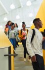 Junior high students descending stairs — Stock Photo