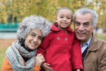 Portrait smiling grandparents with granddaughter — Stock Photo
