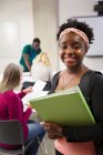 Portrait confident female college student with binder in classroom — Stock Photo