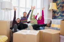 Portrait playful friends taking a break from moving, celebrating and cheering — Stock Photo