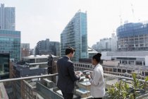 Business people on sunny, urban balcony, Shoreditch, London — Stock Photo