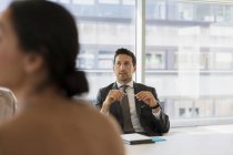 Businessman listening in conference room meeting — Stock Photo