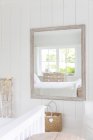 Reflection in mirror of white home showcase bedroom — Stock Photo