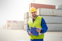 Portrait confident dock worker with clipboard at shipyard — Stock Photo