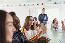 Happy high school students and teacher clapping in debate class — Stock Photo