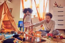 Father and daughter playing with toys on floor — Stock Photo