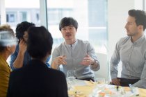 Business people meeting, eating sushi lunch in office — Stock Photo
