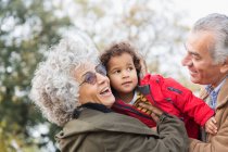 Zärtliche Großeltern umarmen Enkel — Stockfoto