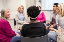 Women talking in support group meeting circle — Stock Photo