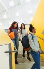 Junior high girl students descending stairs — Stock Photo