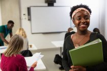Portrait smiling, confident female community college student in classroom — Stock Photo