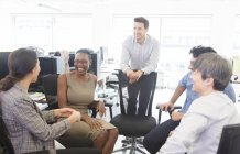 Glückliche Geschäftsleute reden, treffen sich im Großraumbüro — Stockfoto
