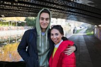 Porträt glückliches junges Paar, das sich am Kanal umarmt — Stockfoto