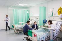 Family visiting patient in hospital ward — Stock Photo