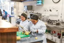 Happy young women with Down Syndrome cooking in cafe — Stock Photo