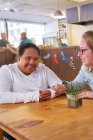 Portrait happy young woman with Down Syndrome in cafe — Stock Photo