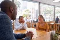Mentor and young women with Down Syndrome talking in cafe — Stock Photo