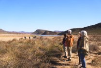 Senior friends on safari watching zebras in distance South Africa — Stock Photo