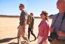 Safari tour guide and group walking in arid desert South Africa — Stock Photo