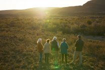 Safari tour group watching elephants in sunny grassland South Africa — Stock Photo