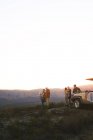 Safari tour group drinking tea on hill at sunrise South Africa — Stock Photo