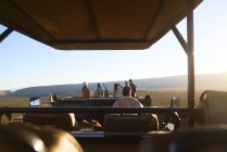 Safari tour group looking at view off-road vehicle South Africa — Stock Photo