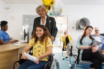 Portrait smiling girl patient in wheelchair at clinic — Stock Photo