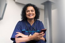 Portrait confident female doctor using smart phone — Stock Photo