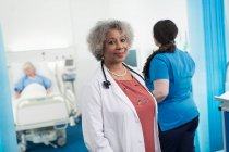 Portrait confident female senior doctor in hospital room — Stock Photo