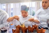 Young woman with Down Syndrome in baking class — Stock Photo